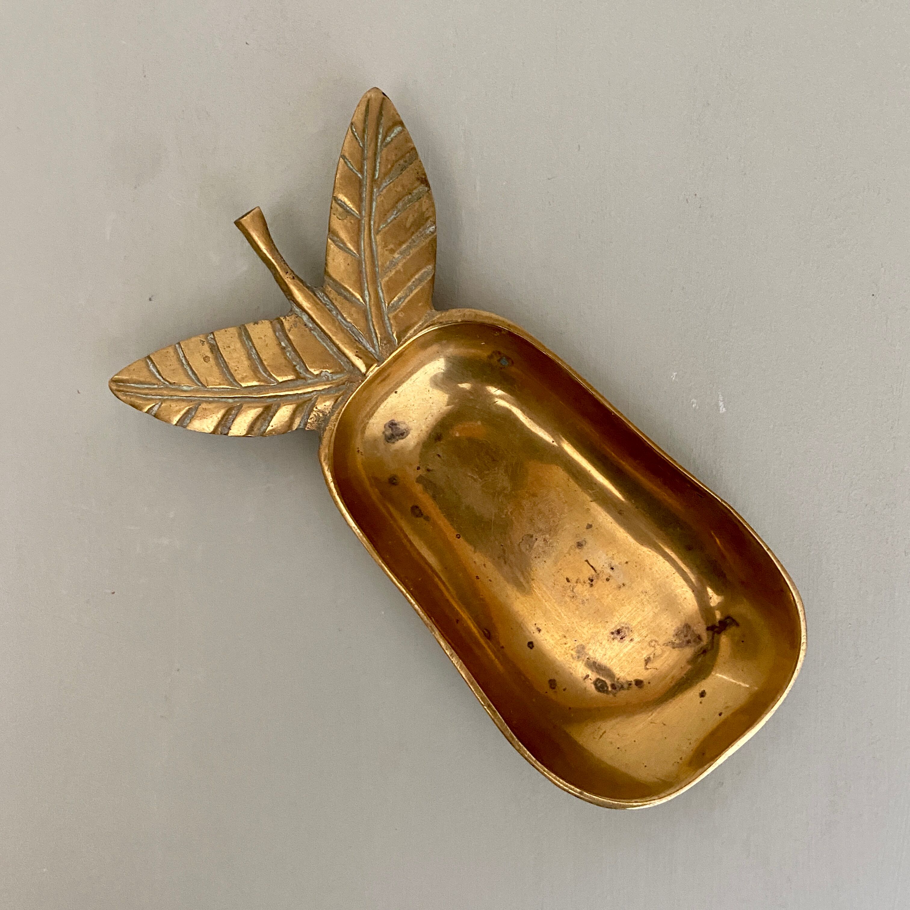 Empty vintage pear-shaped brass pocket