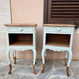 Renovated bedside tables in laurel green and light wood.