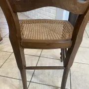 Pair of antique caned and wooden chairs from the 1900s.