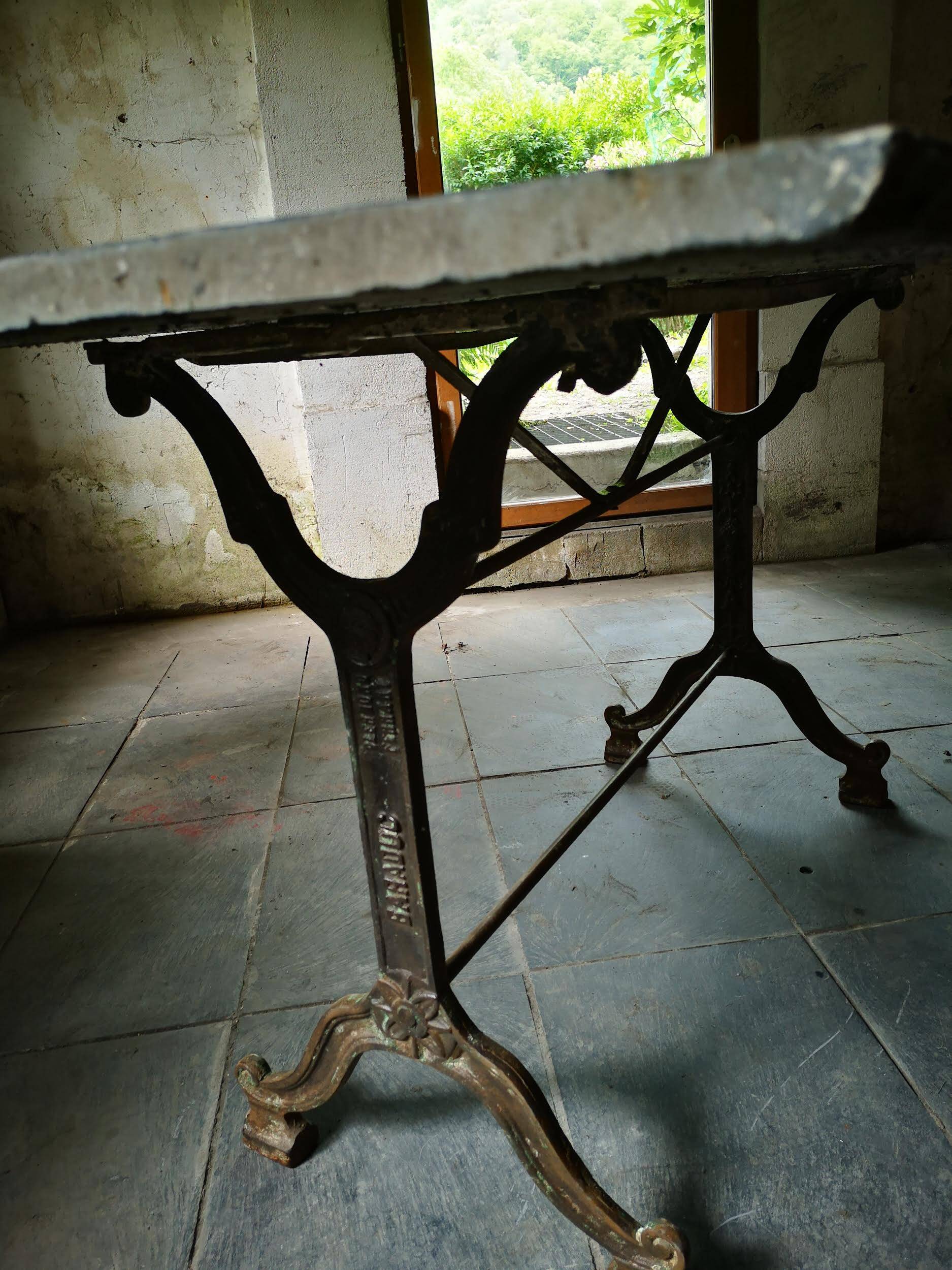 Old bistro table – cast iron legs and natural slate top