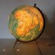 Luminous world map in tripod glass