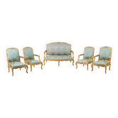 Louis XV style living room with gilded wooden frames. Circa 1880.