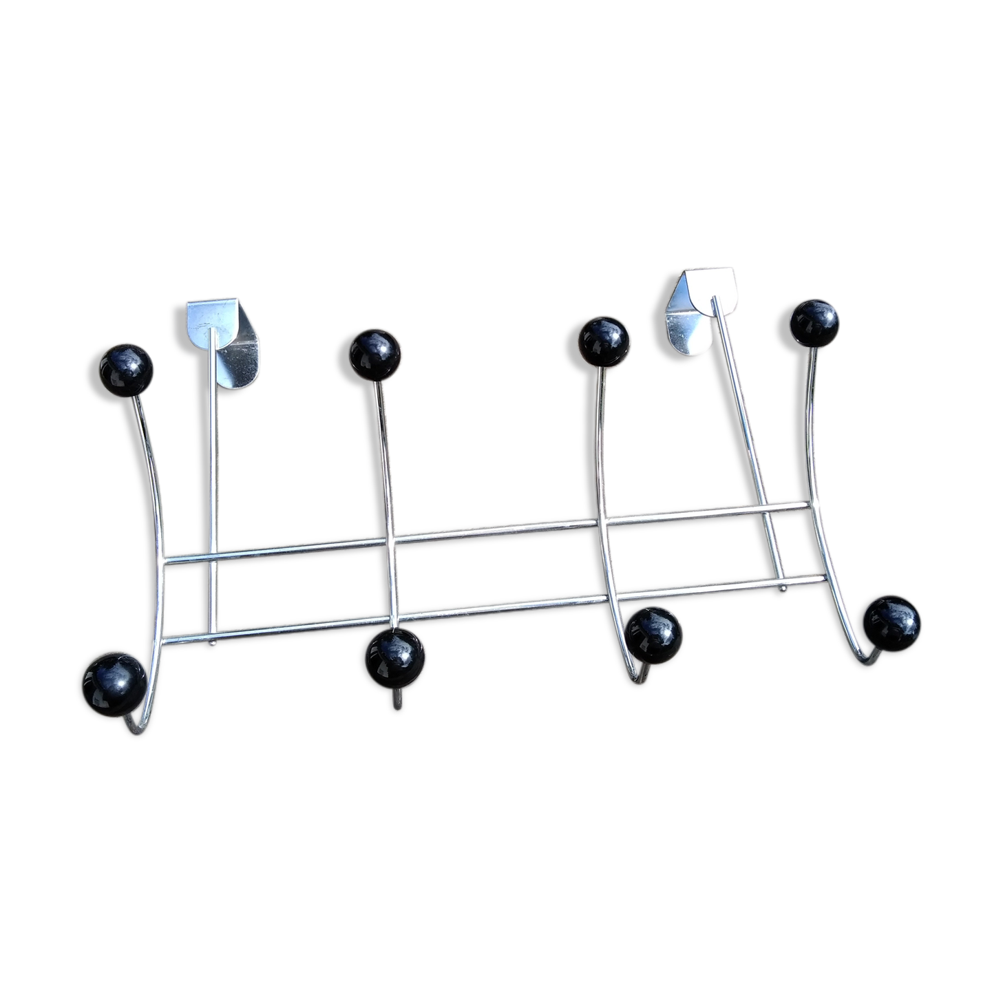 Coat rack that hangs at the top of a door