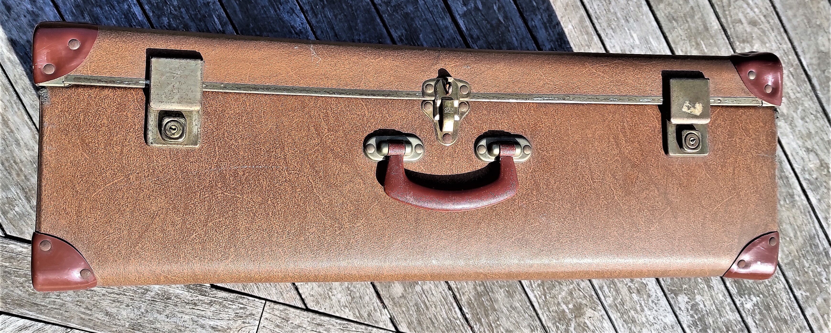 Brown vintage suitcase with CHENEY England brand travel tags