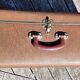 Brown vintage suitcase with CHENEY England brand travel tags