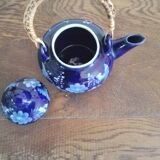 Small blue teapot and its wicker handle
