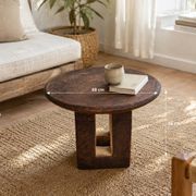 African monoxyle side table in carved wood with a curved top, 48x36 cm.