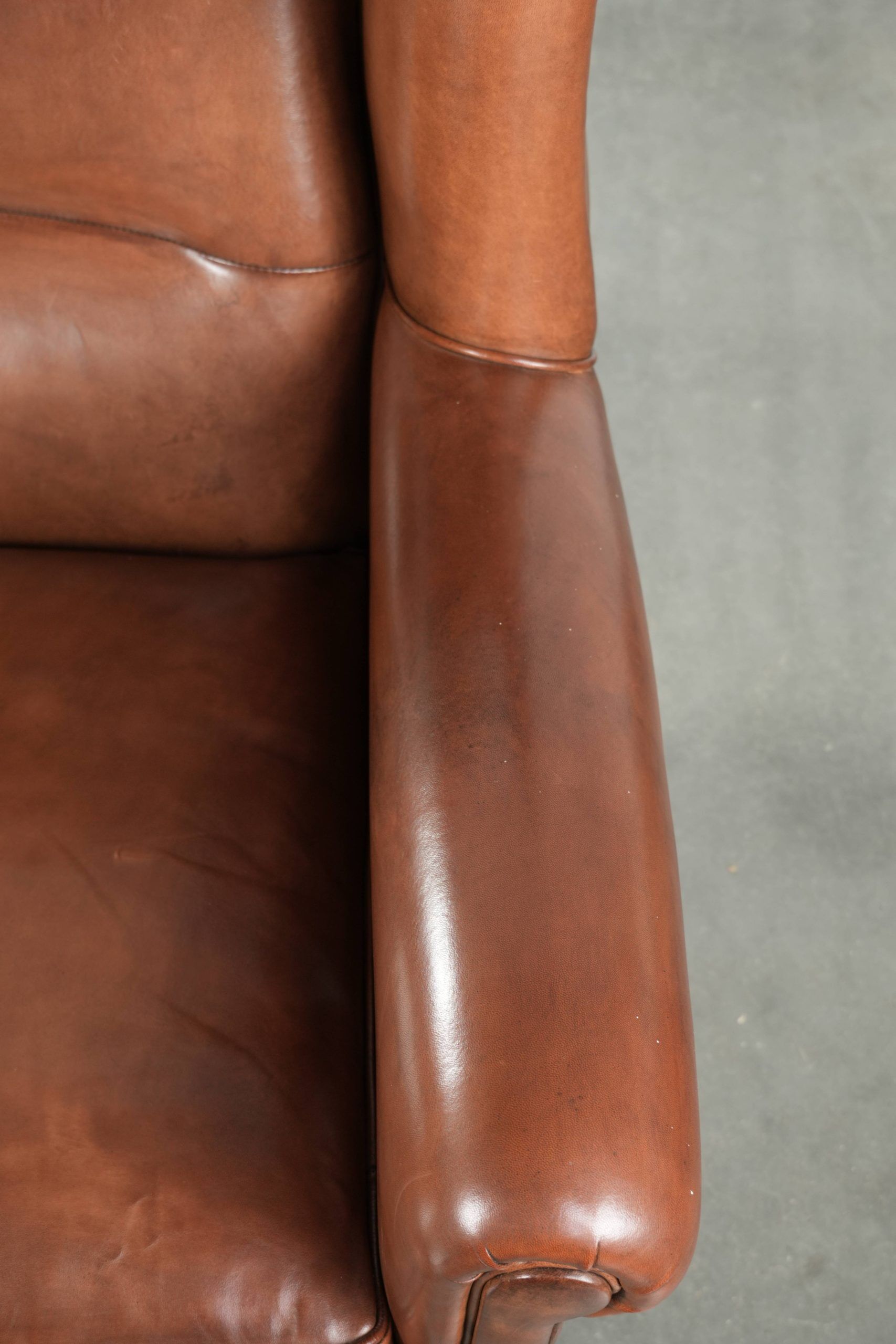 Large sheepskin wingback armchair in timeless English style