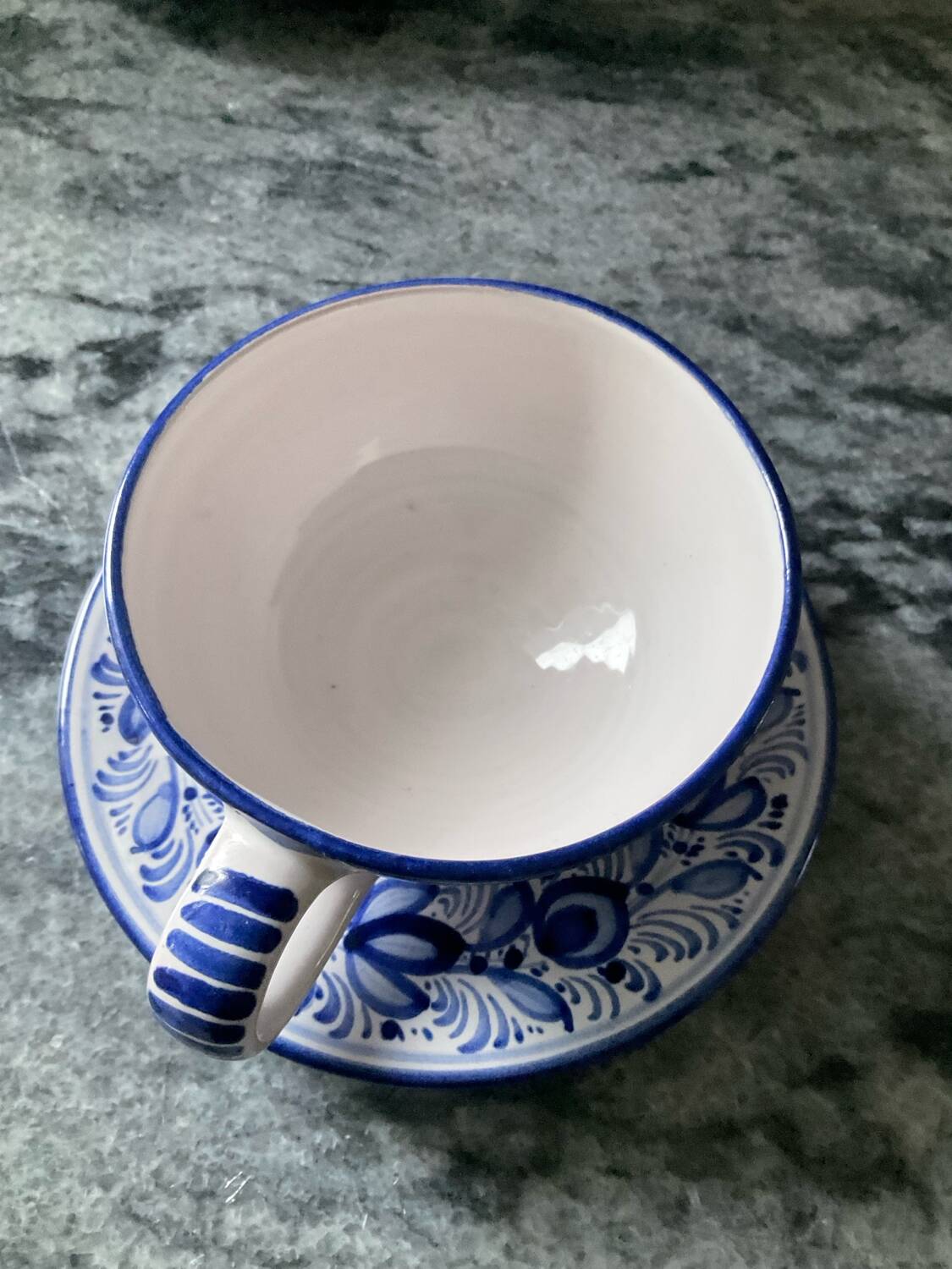 Set of 4 white/blue ceramic cups and saucers.