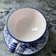 Set of 4 white/blue ceramic cups and saucers.