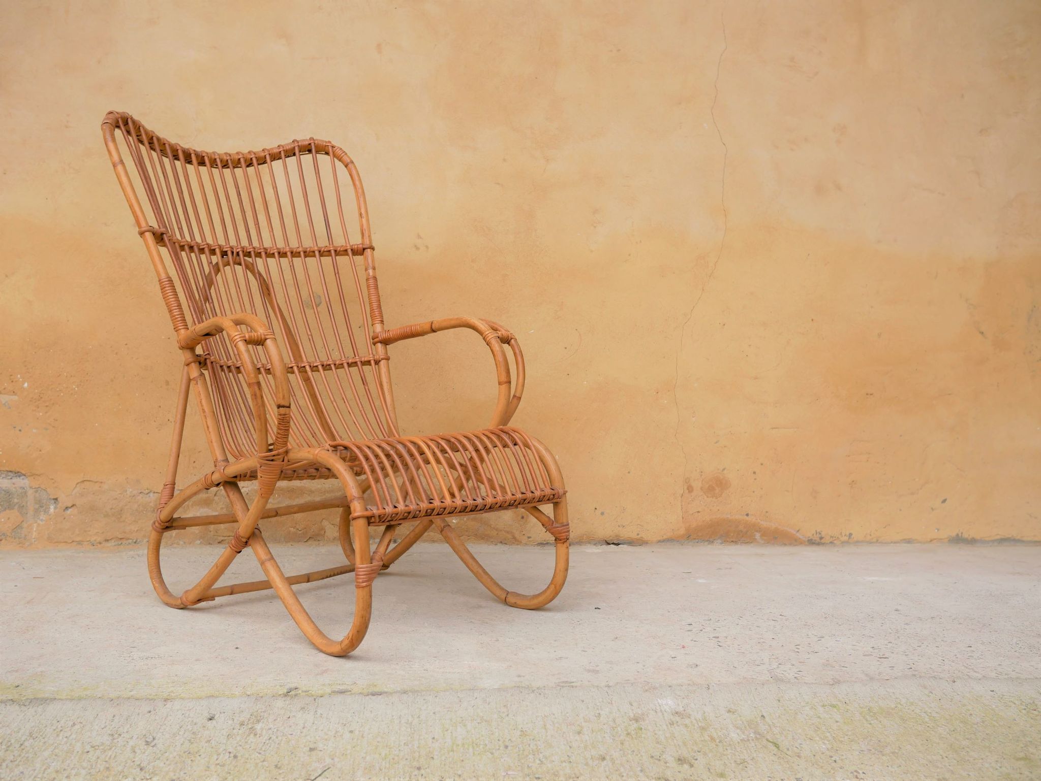 Vintage rattan chair by Louis Sognot