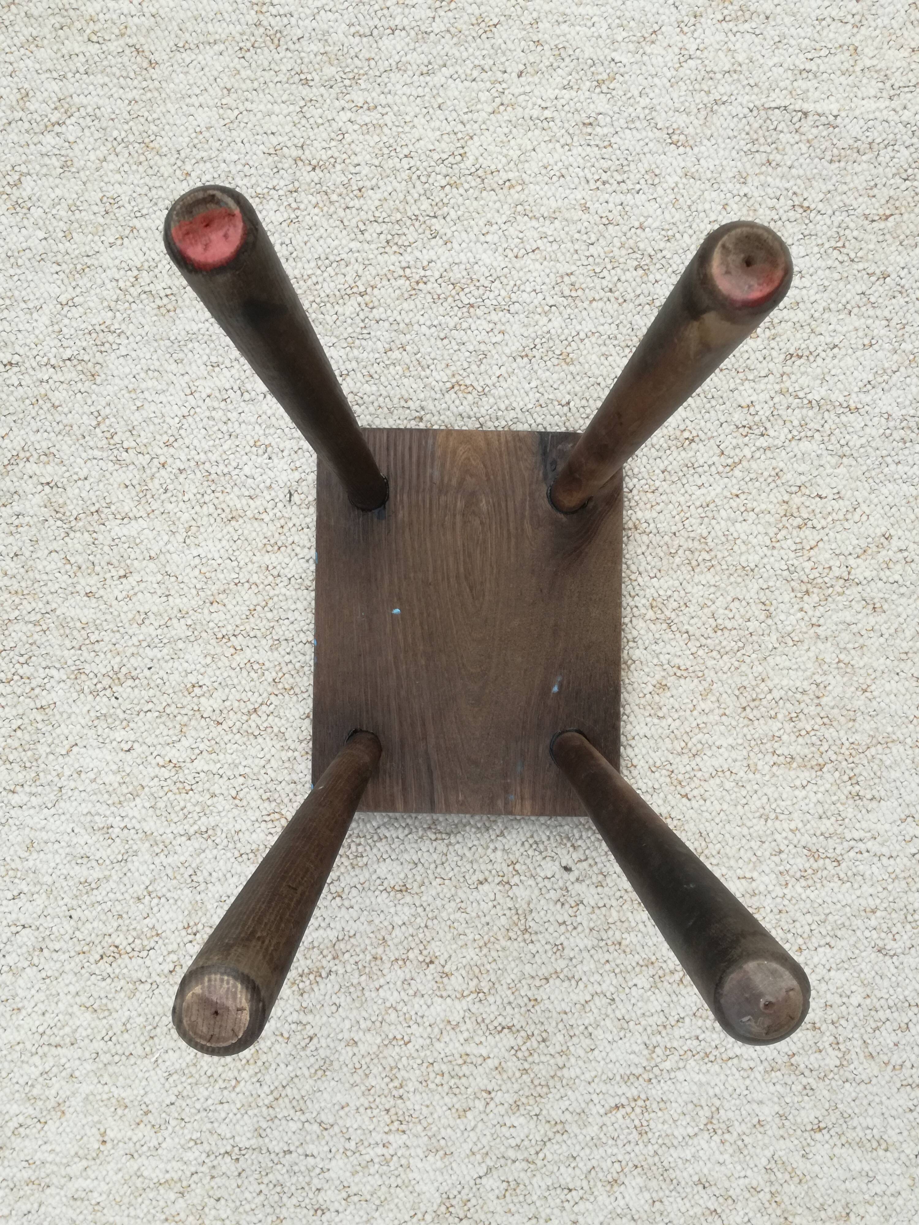 Old wooden stool with log feet