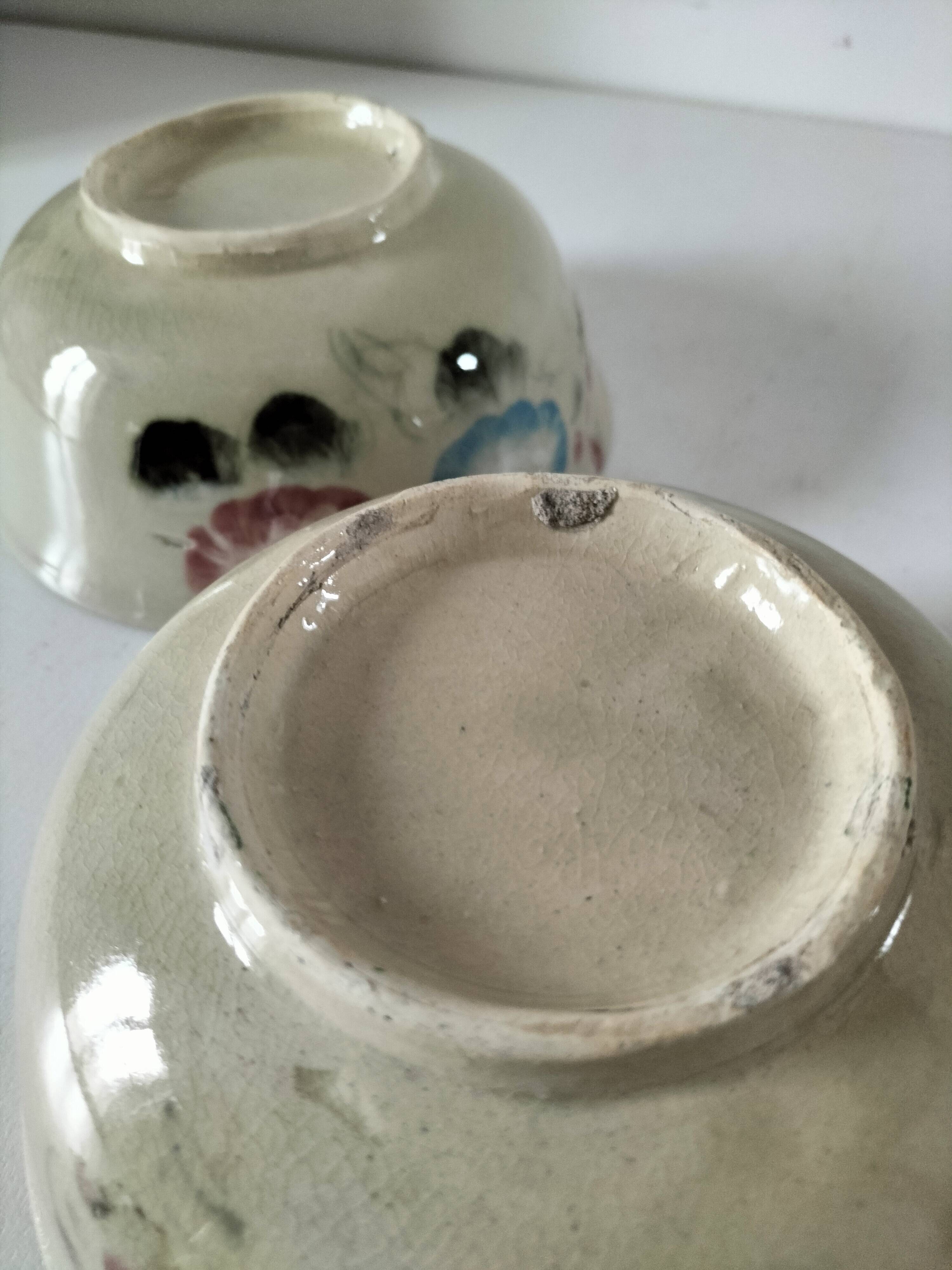 Two large vintage bowls in pastel decor on mini pedestals.