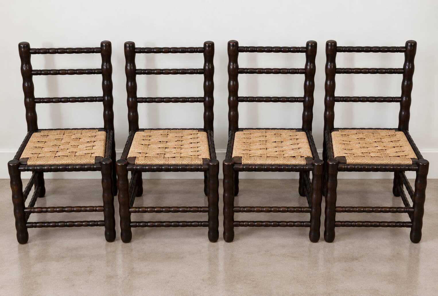 4 blackened wood spindle leg chairs attributed to Charles Dudouyt 1940