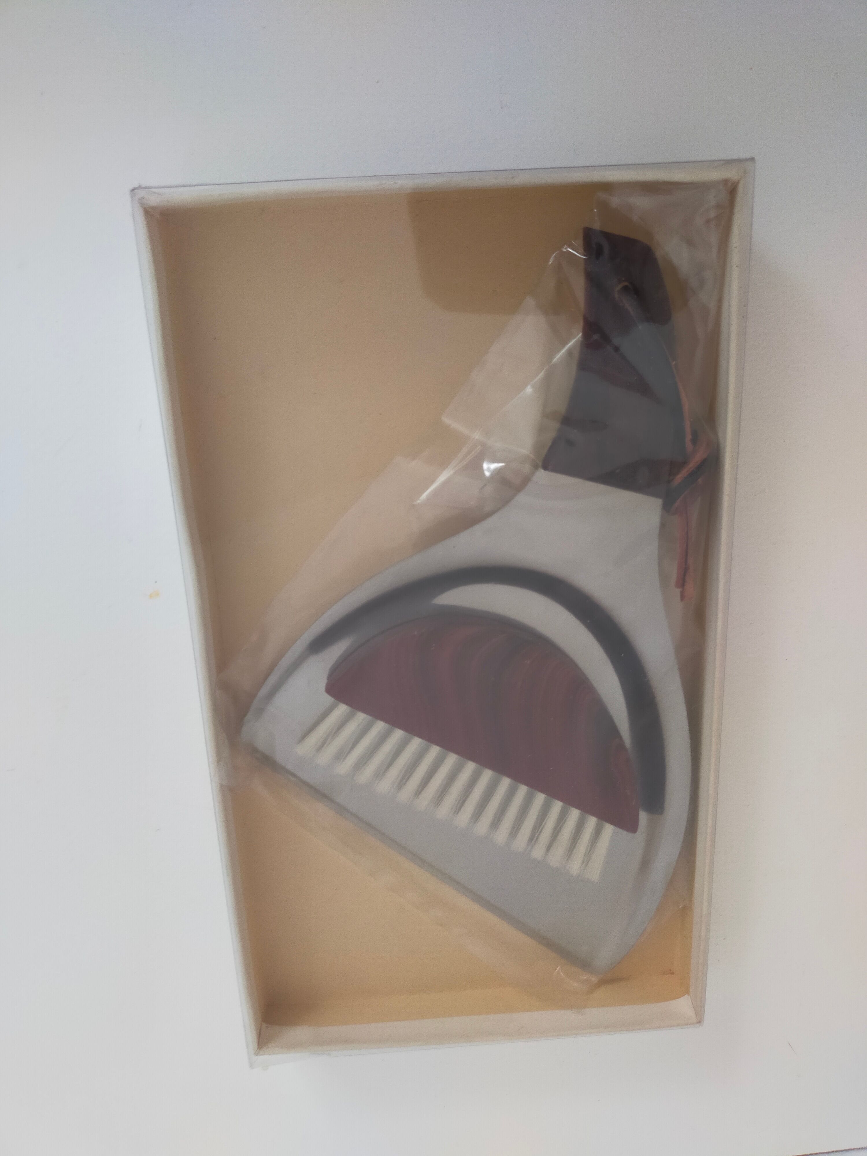 Picks up new vintage shovel and sweeper crumbs