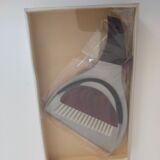 Picks up new vintage shovel and sweeper crumbs