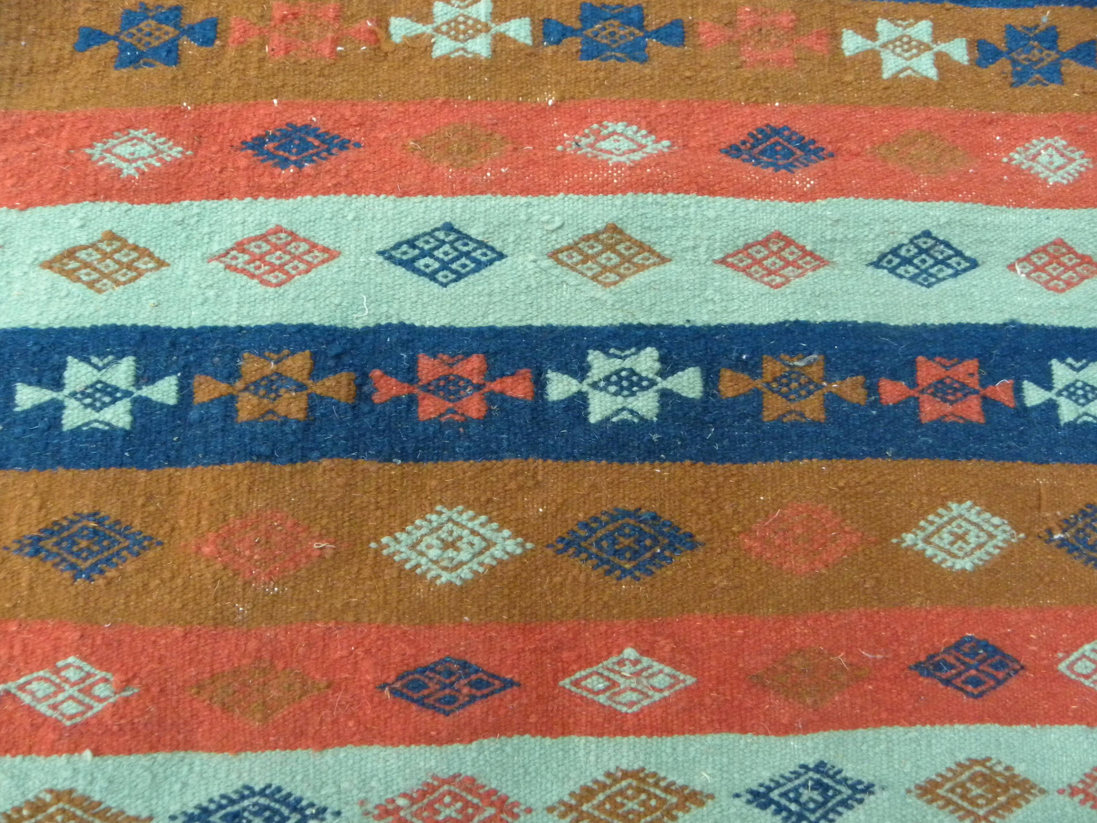 Authentic handmade Tunisian Berber kilim rug in orange wool.