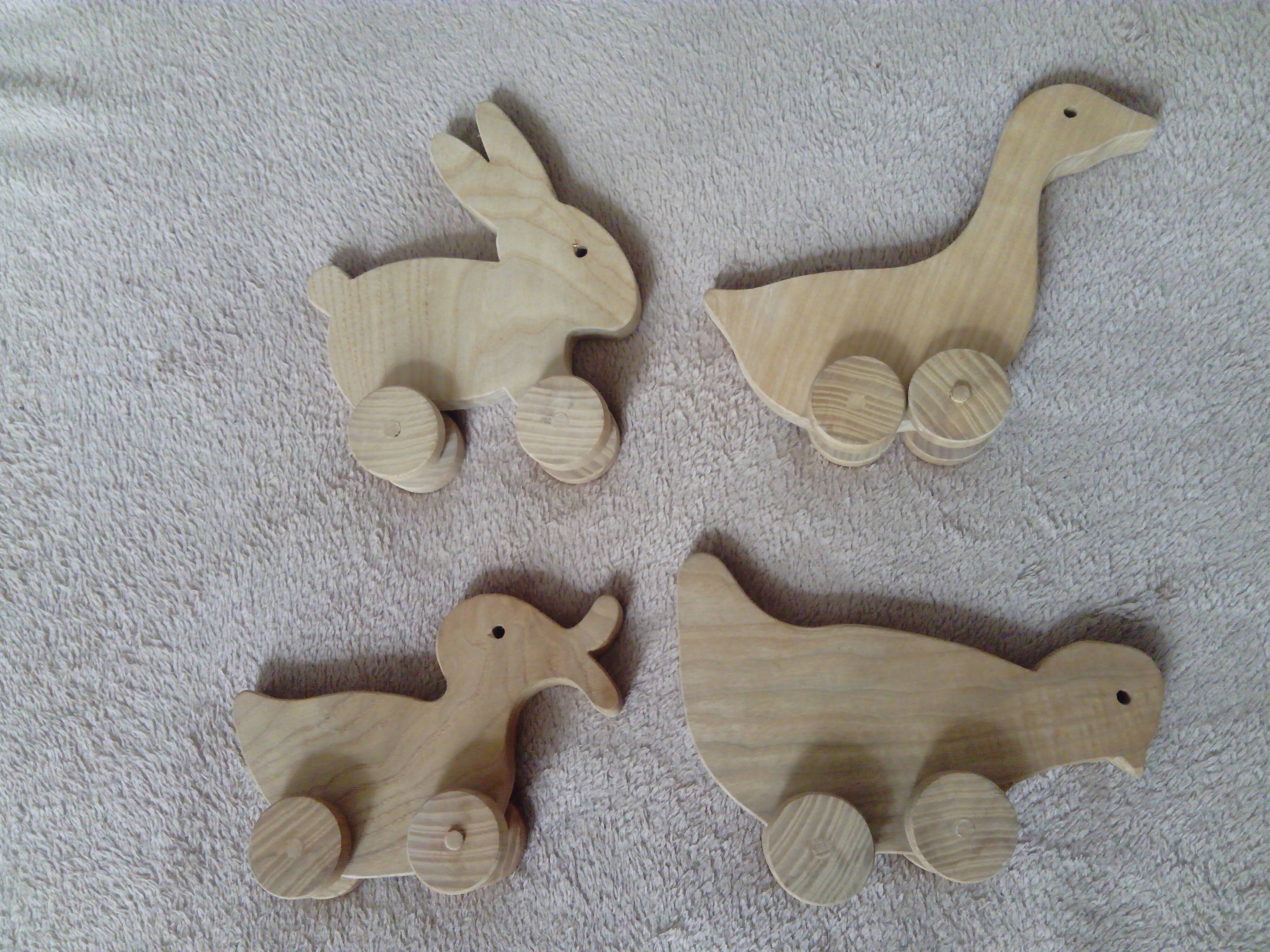 set of 4 wooden toys on wheels
