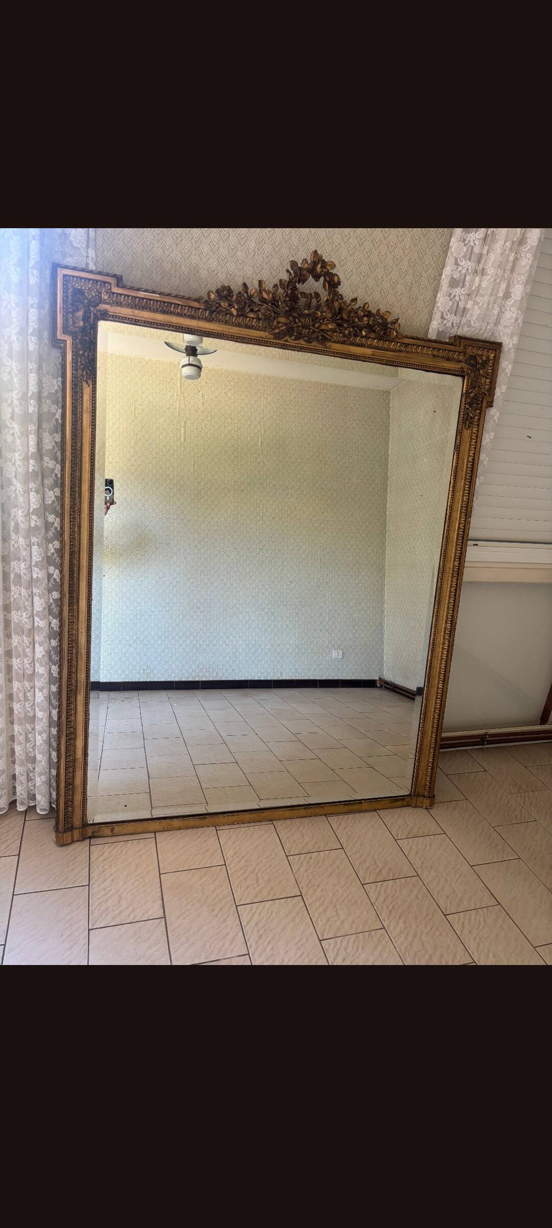 Large mirror from the Napoleonic III era with a floral pediment.