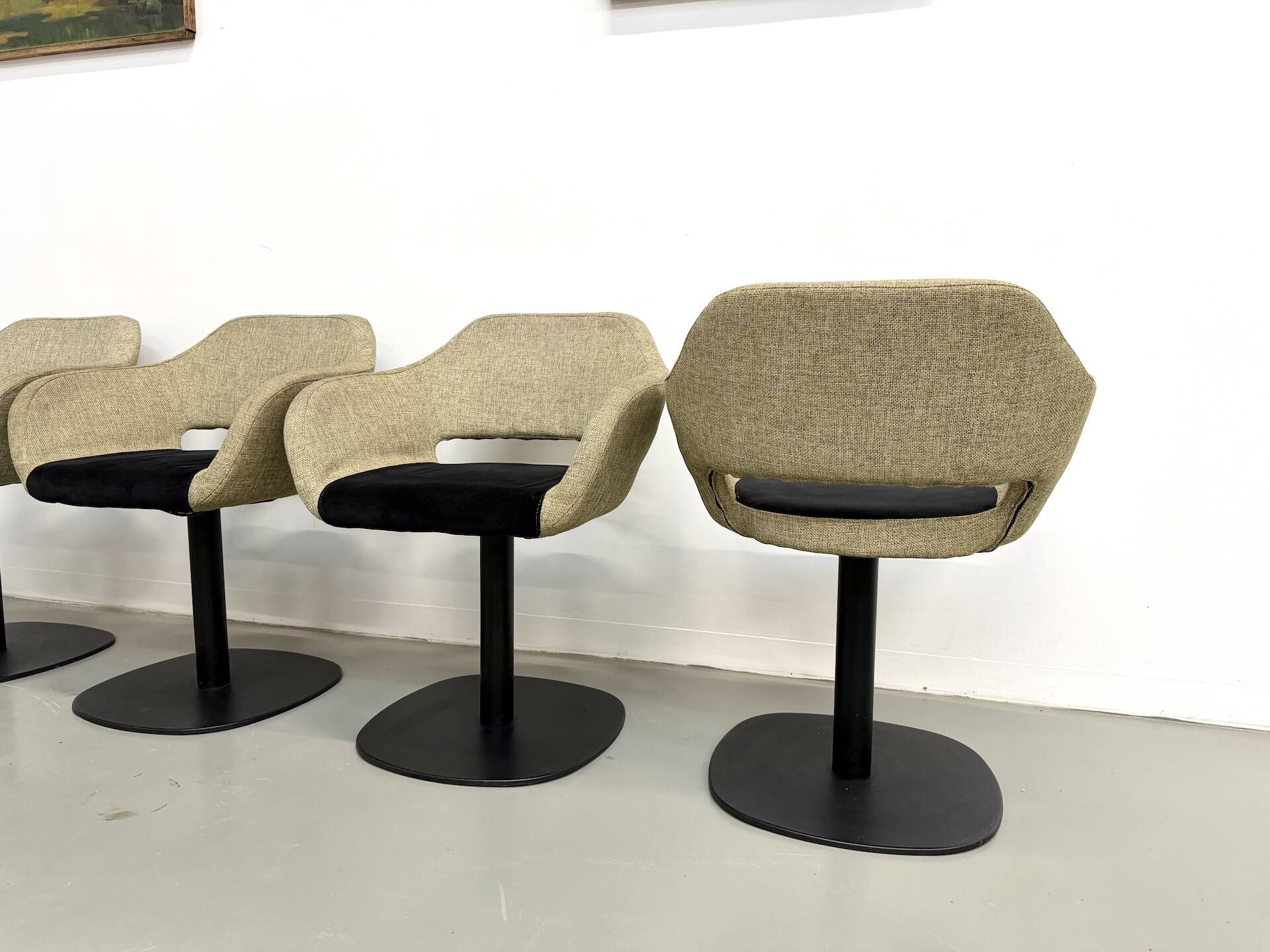 Series of six swivel chairs with an organic shell, patterned fabric and base.