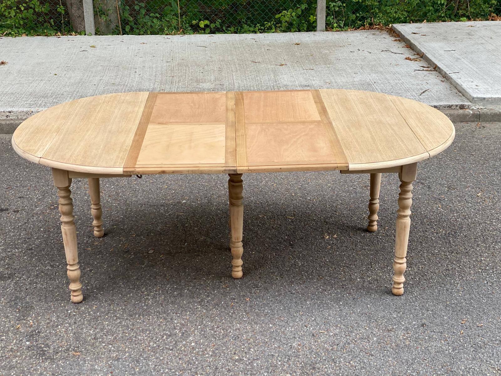 Round dining table with extendable leaves, Louis Philippe style, stripped in raw oak.