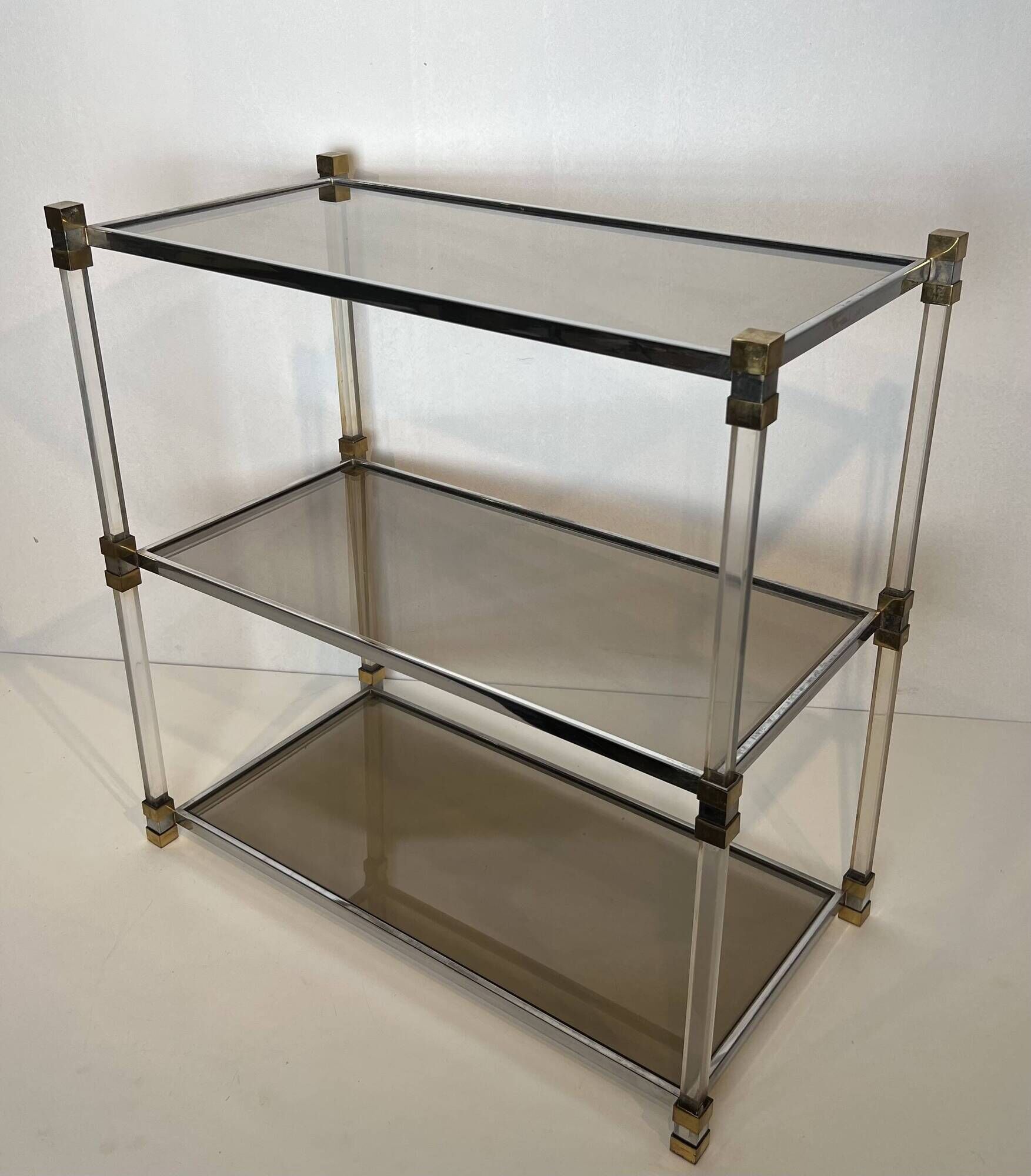 Lucite Shelf with Three Smoked Glass Shelves and Brass Ends. Work