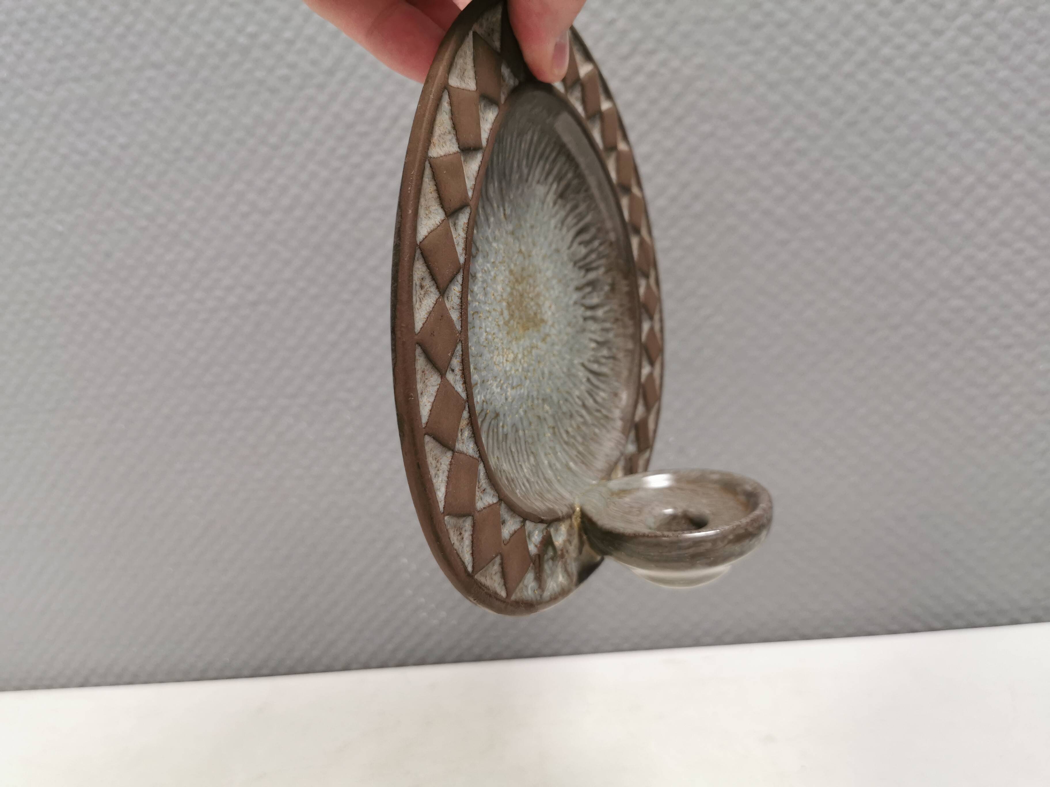 Wall-mounted candlestick in grayish colors, Danish and from the 1970s-80s.