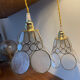 Pair of portable lamps with mother-of-pearl lampshades and brass.