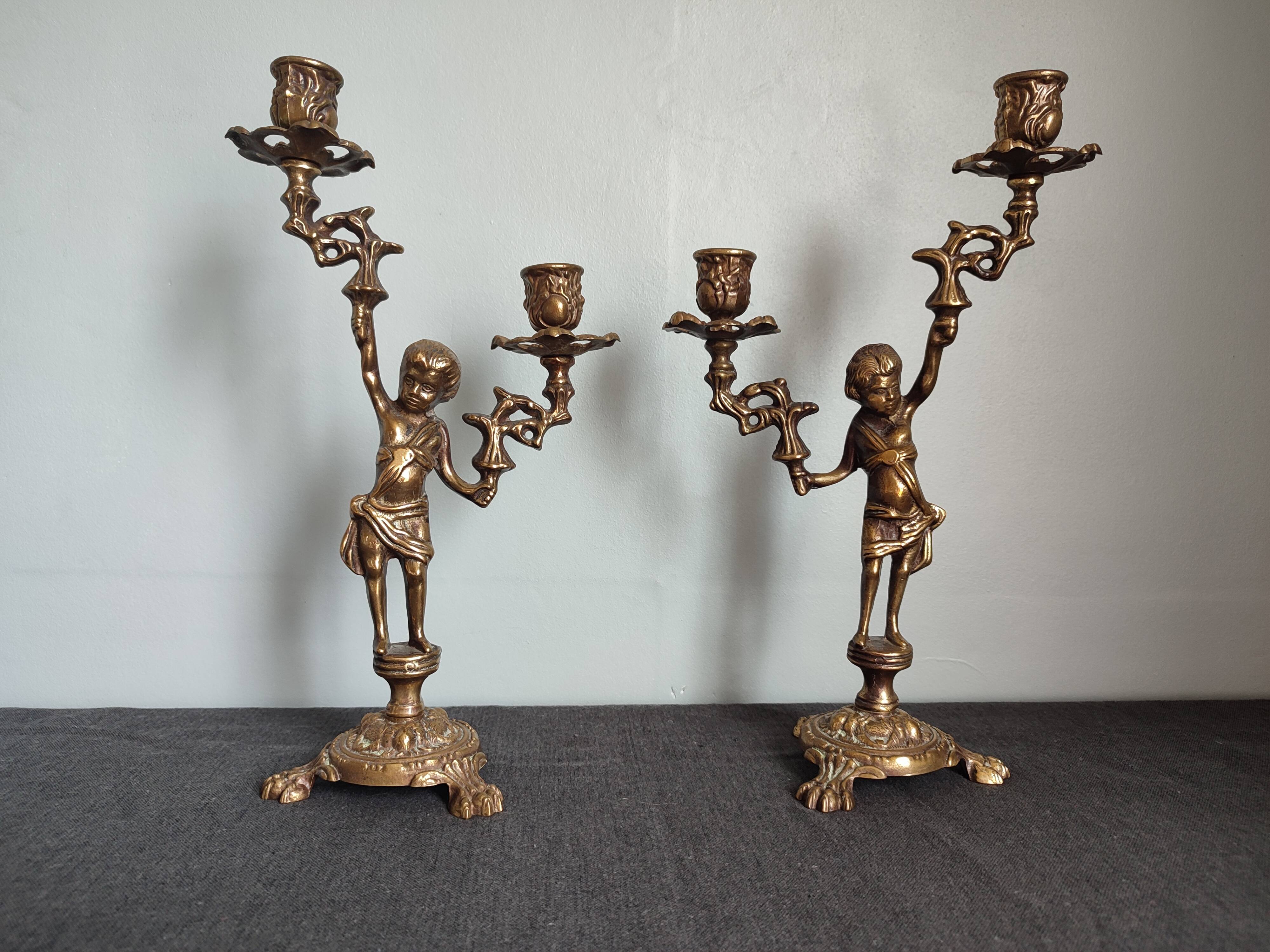 Pair of antique candlesticks in cherub bronze