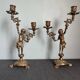 Pair of antique candlesticks in cherub bronze
