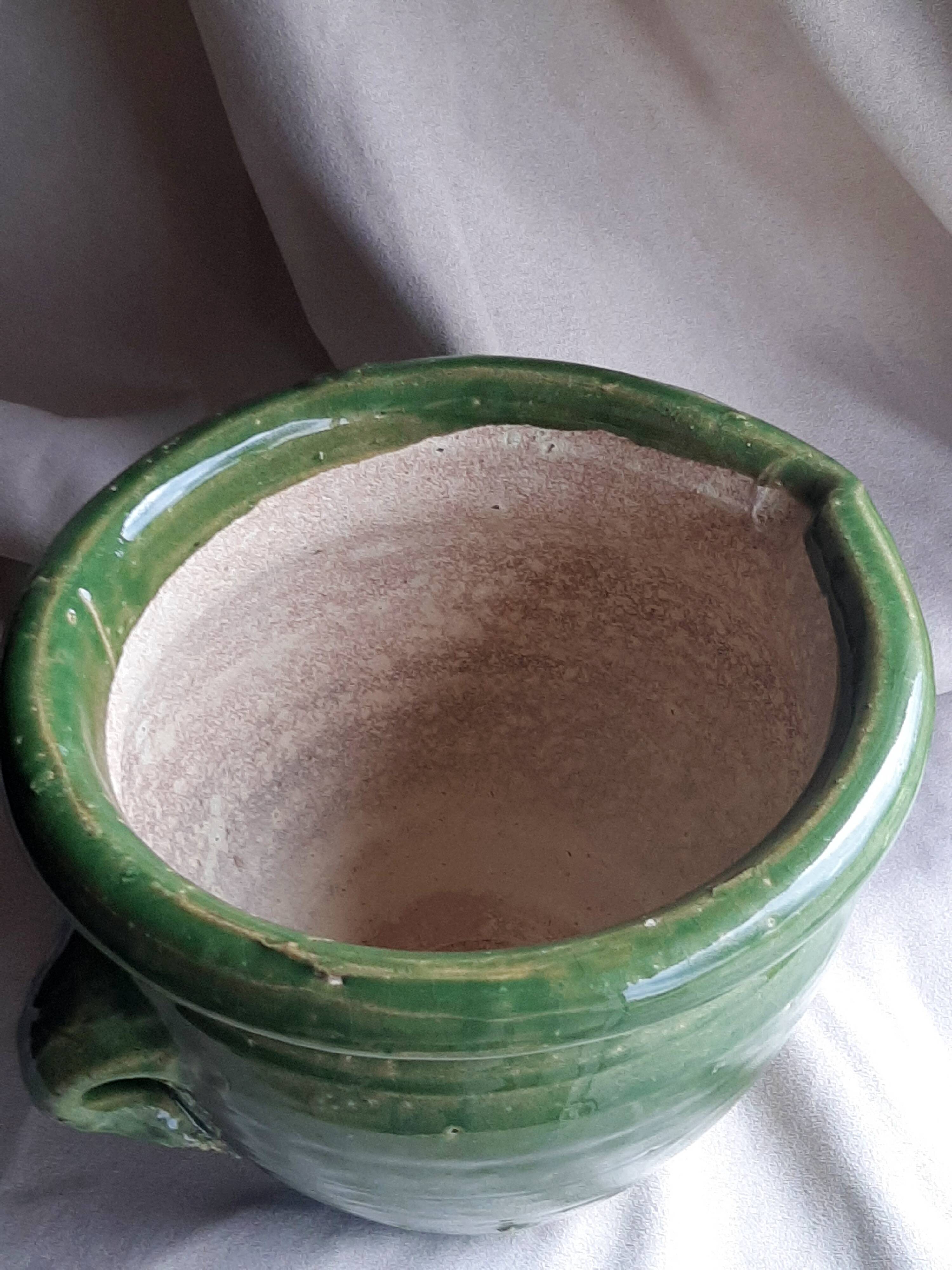 Glazed green terracotta pot.