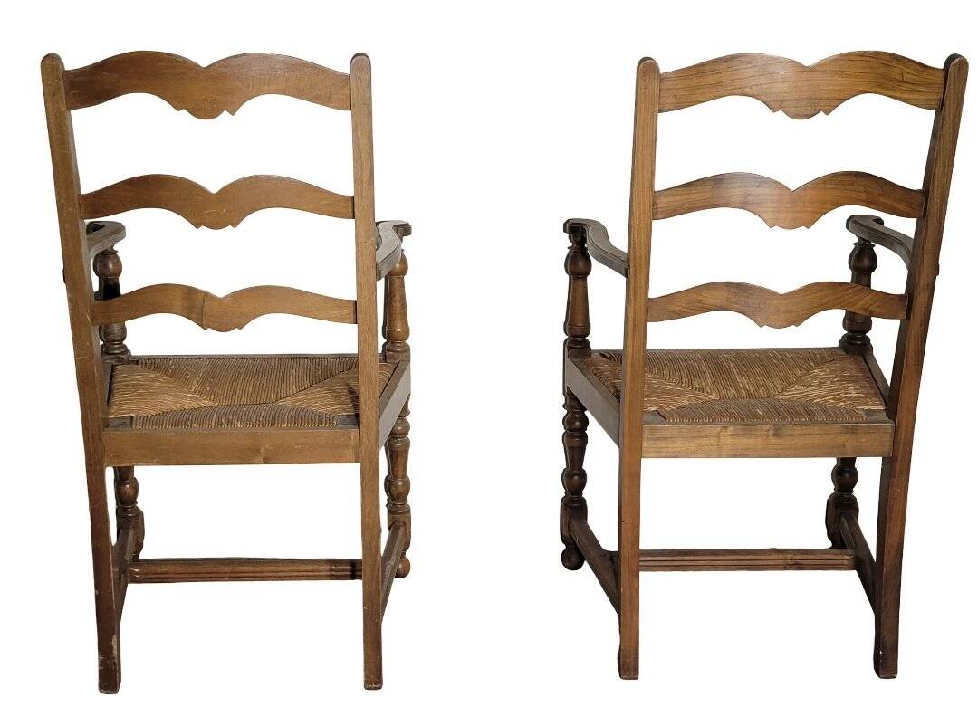 Pair of rustic antique armchairs in wood and woven straw.