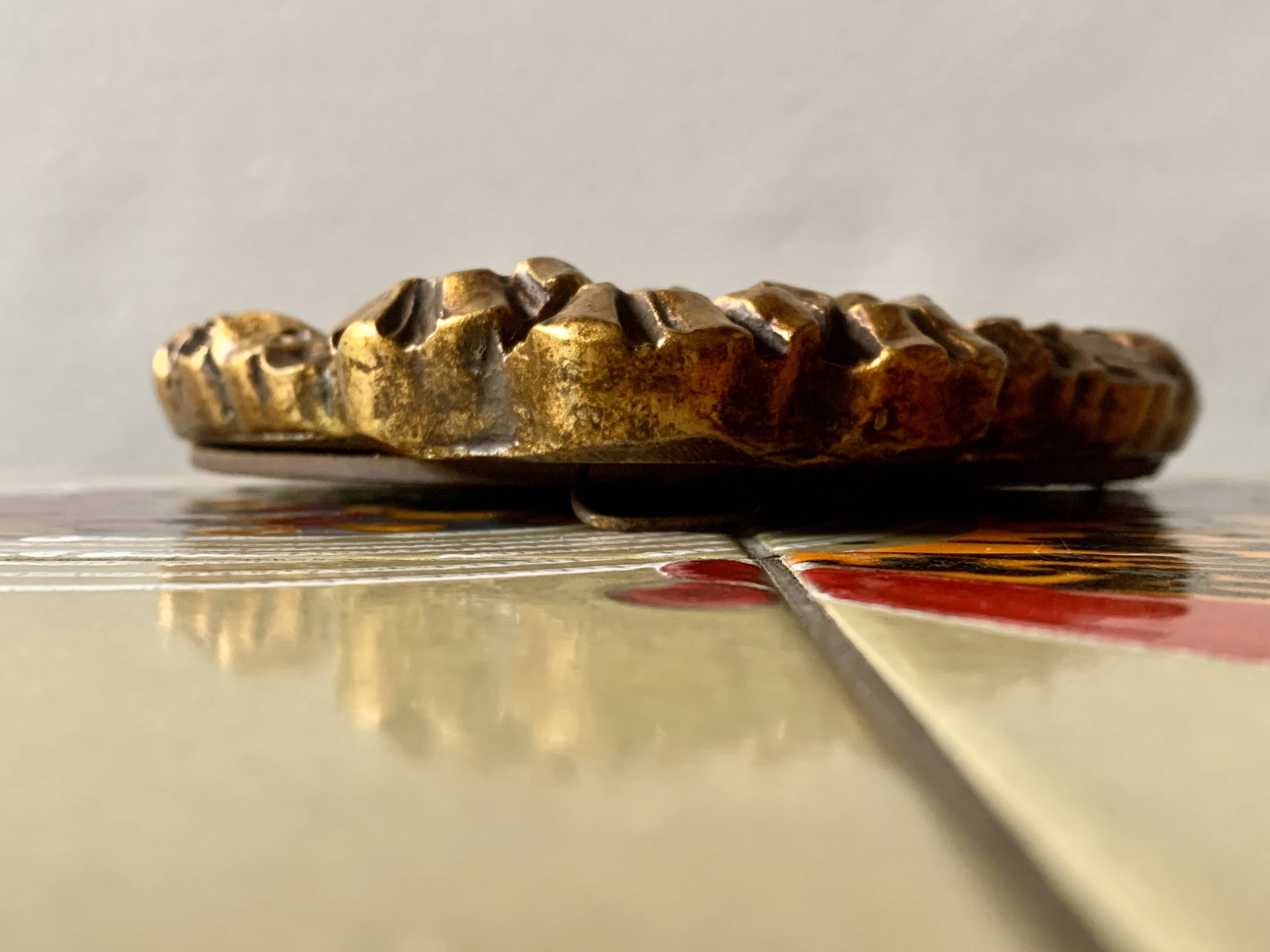 Small vintage oval wall mirror in varnished gold resin