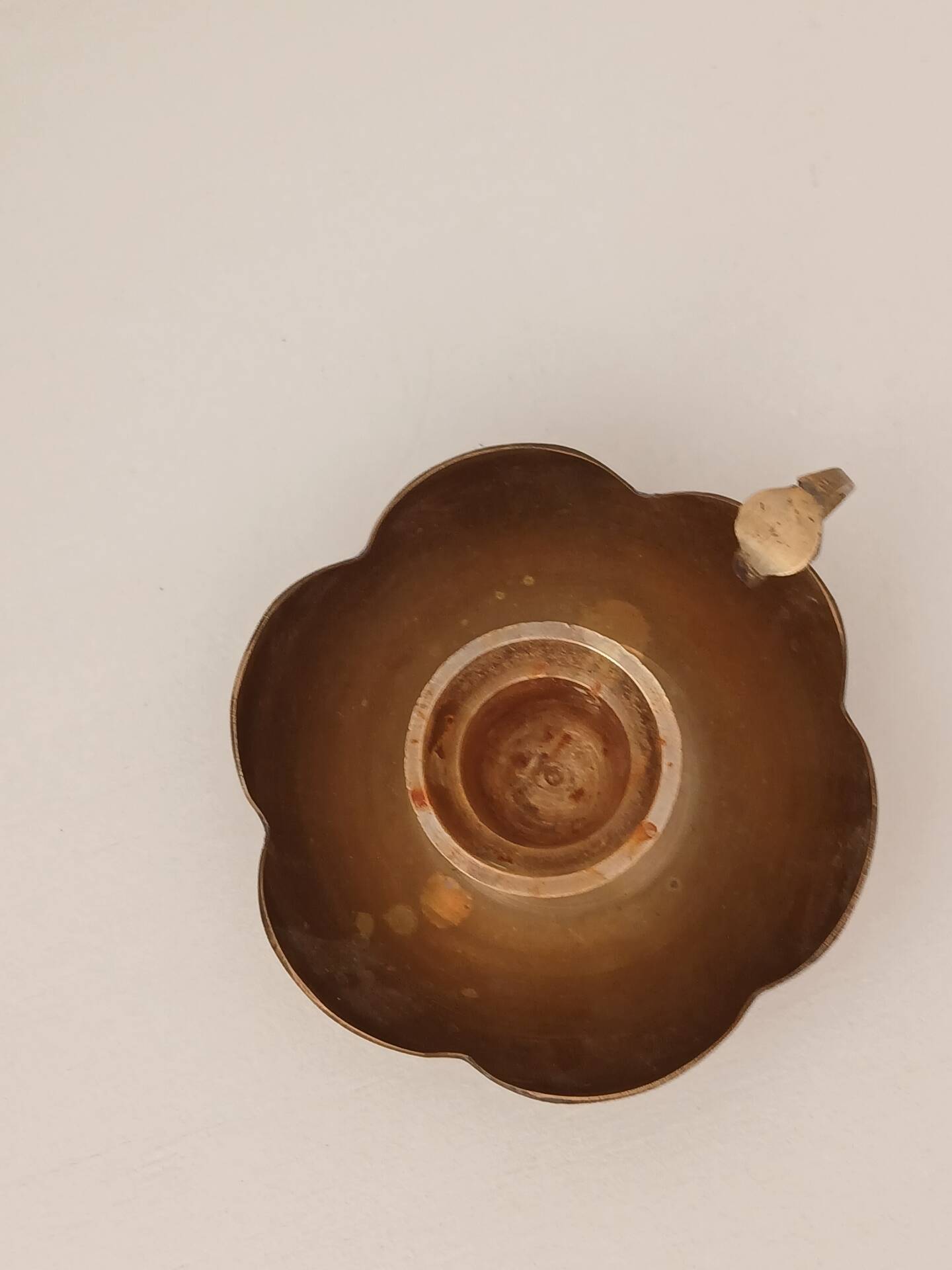 Brass candle holder in the shape of a flower.