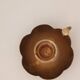 Brass candle holder in the shape of a flower.