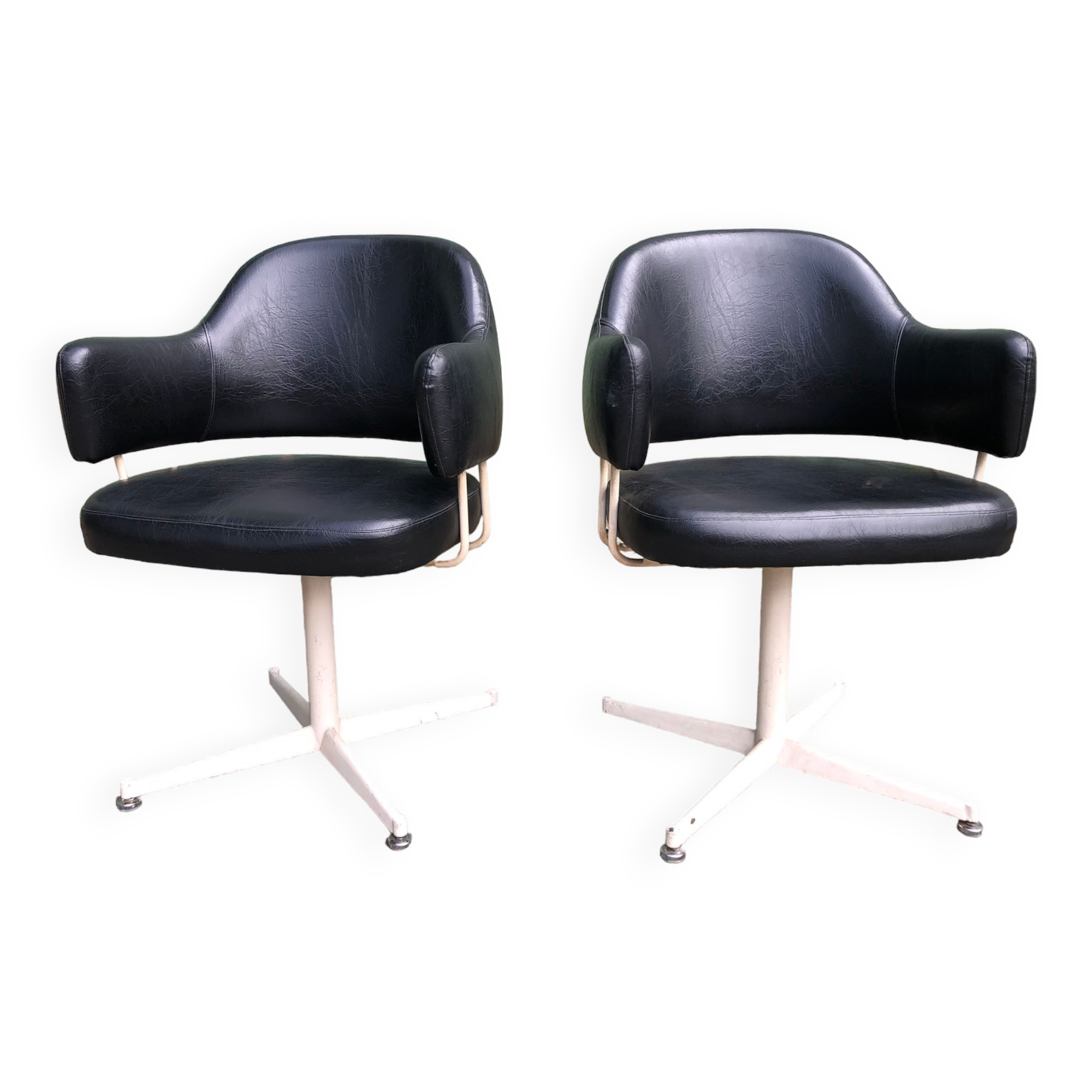 Pair of vintage armchairs in black skai with metal legs.