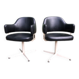 Pair of vintage armchairs in black skai with metal legs.