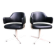 Pair of vintage armchairs in black skai with metal legs.