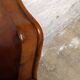 Antique club chair with gendarme hat back