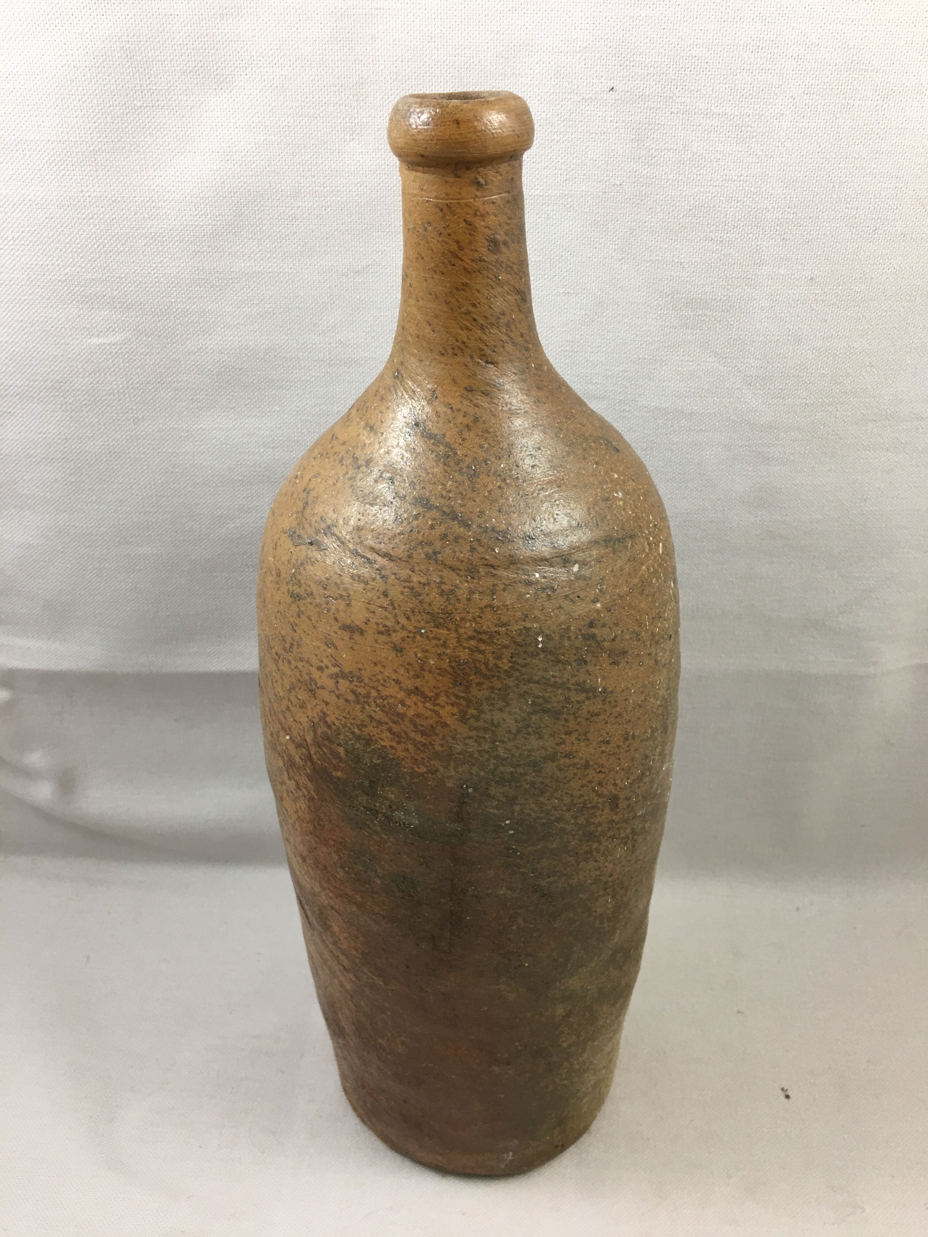 Old bottle in varnished sandstone glazed vintage