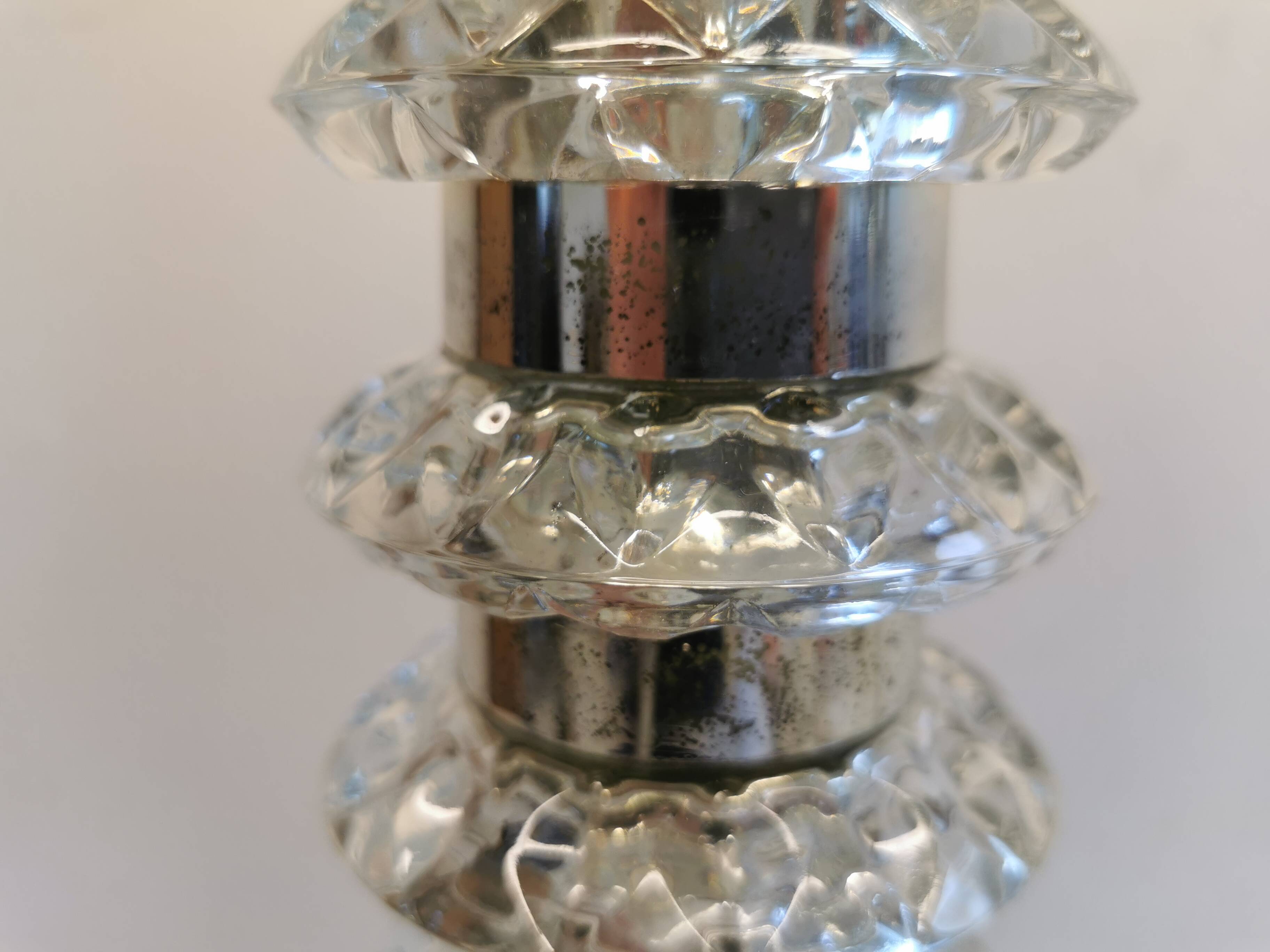 Table lamp made of transparent crystal glass and silver colored spacers.