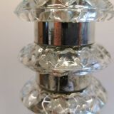 Table lamp made of transparent crystal glass and silver colored spacers.