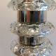 Table lamp made of transparent crystal glass and silver colored spacers.
