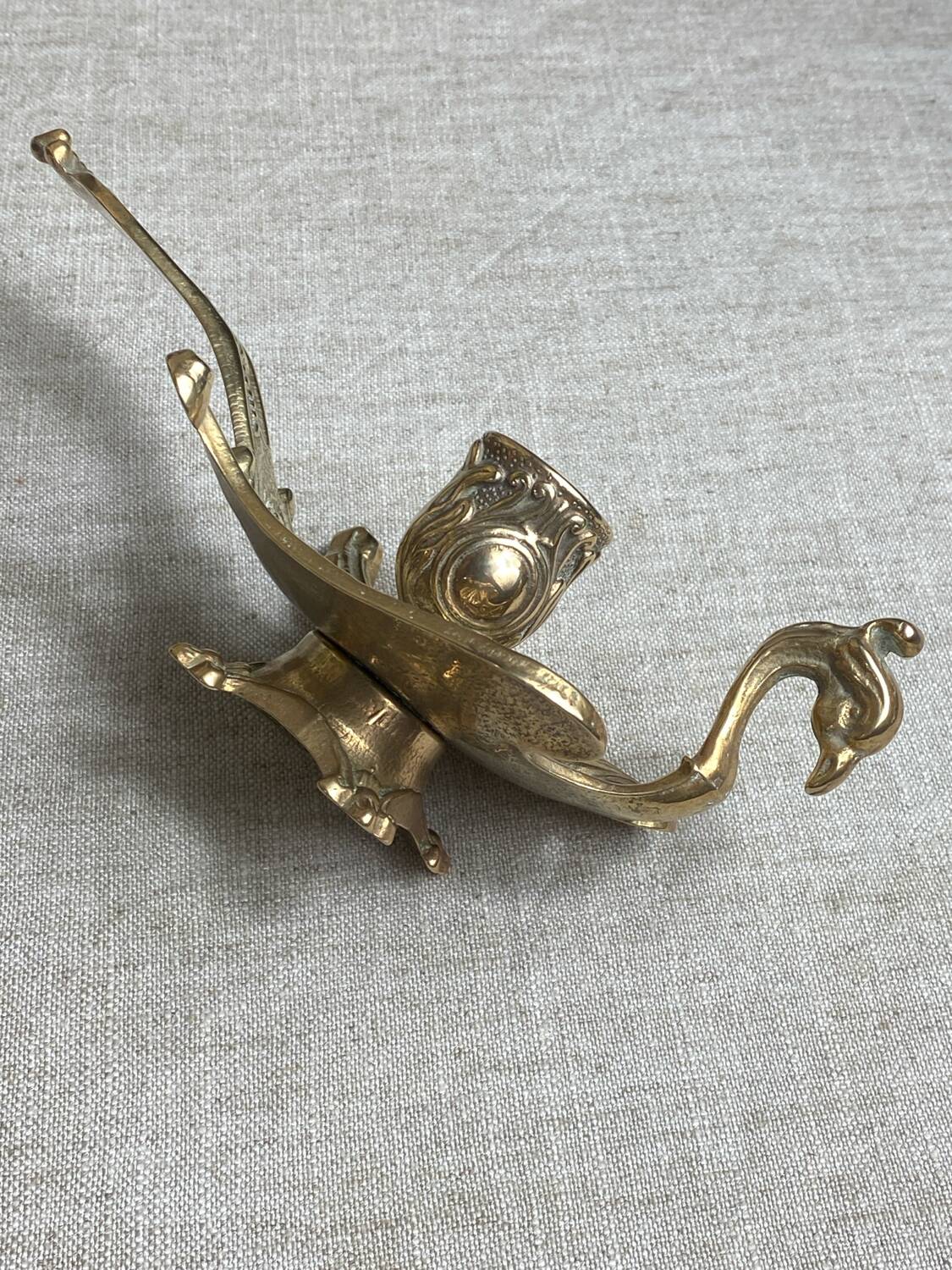 Bronze hand candlestick in the shape of a peacock