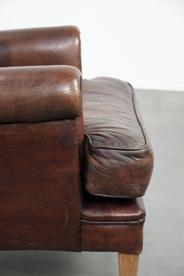 Characterful sheep leather armchair with a beautiful deep colour