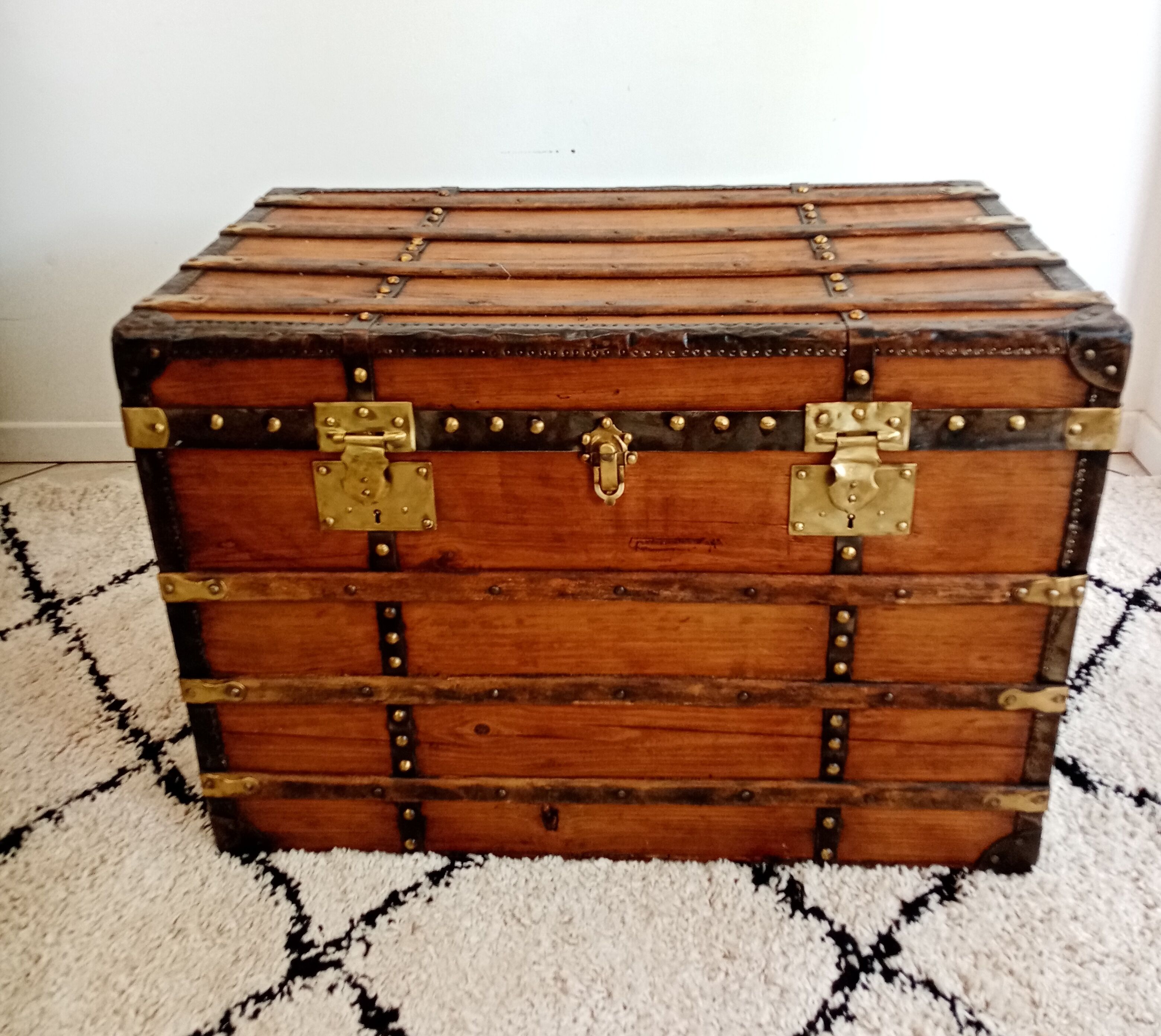 Restored varnished wooden antique travel trunk