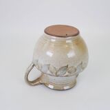 Glazed ceramic jug with plant decoration