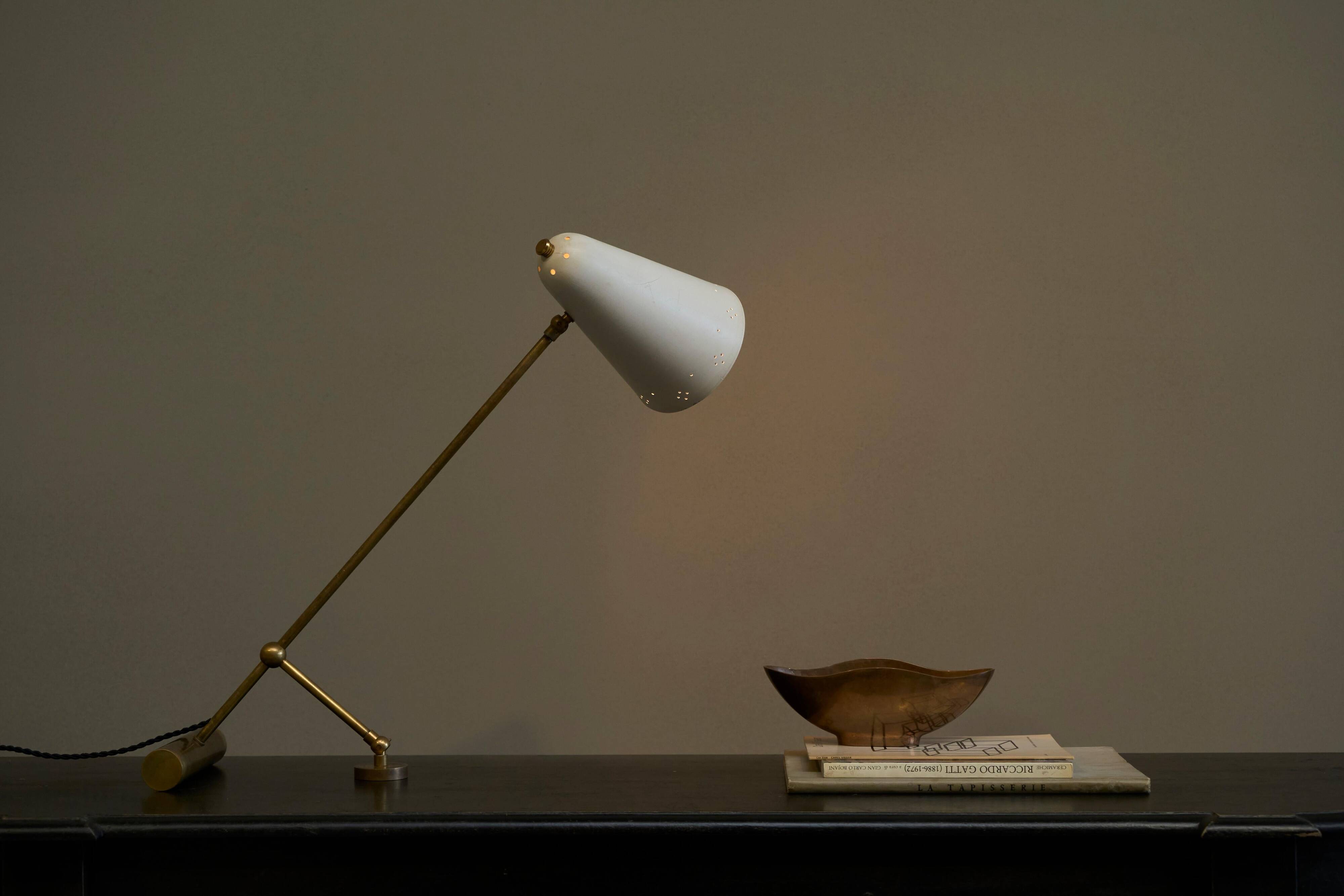 Mid Century adjustable table lamp with perforated shade from the 1950s.