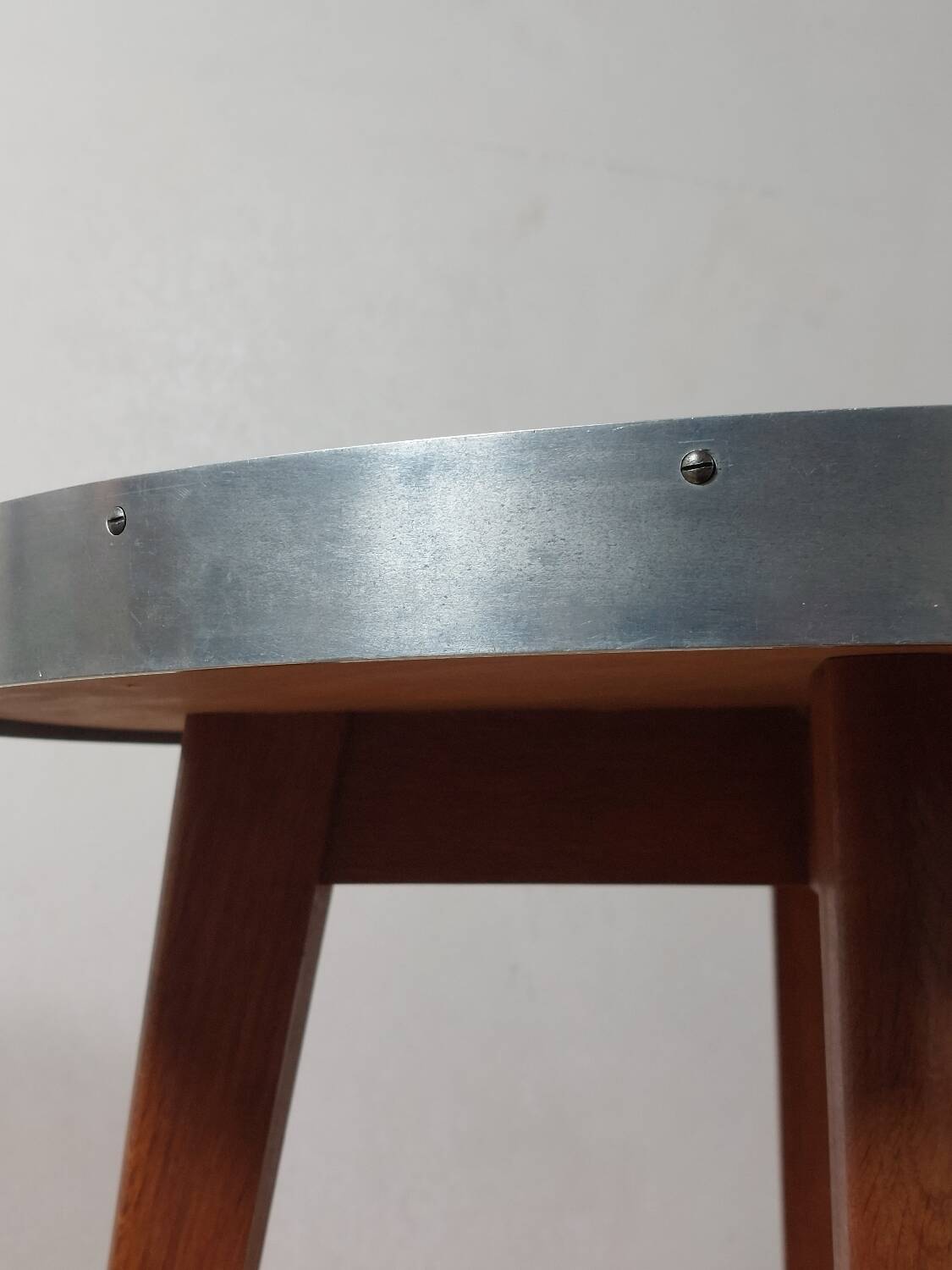 Vintage metal and teak side table from the 1950s.