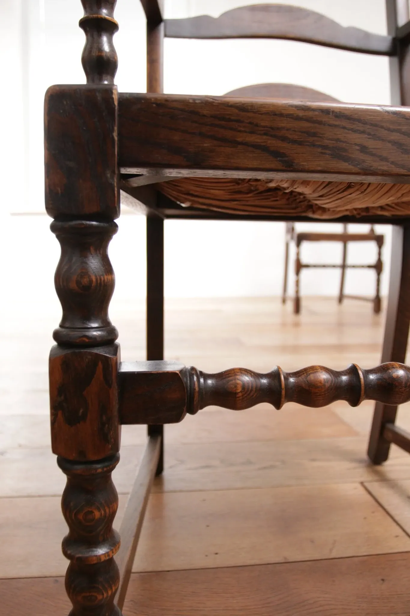 Pair of English oak armchairs with ladder back and rush seats
